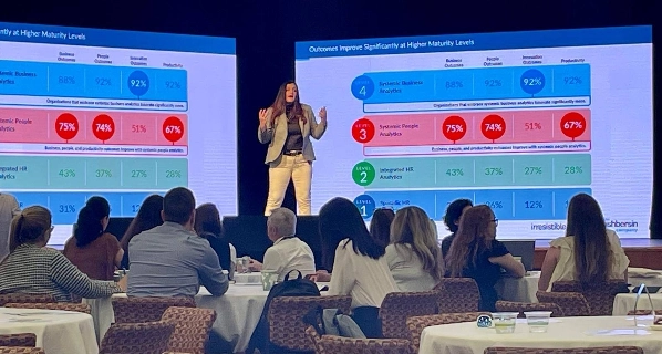 On stage presenting slides to an audience